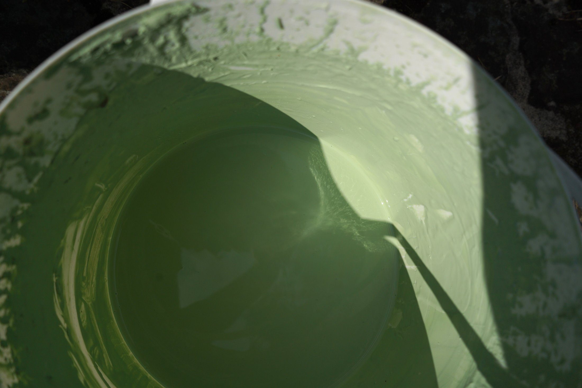 Green glaze prepared in-house in a studio bucket.