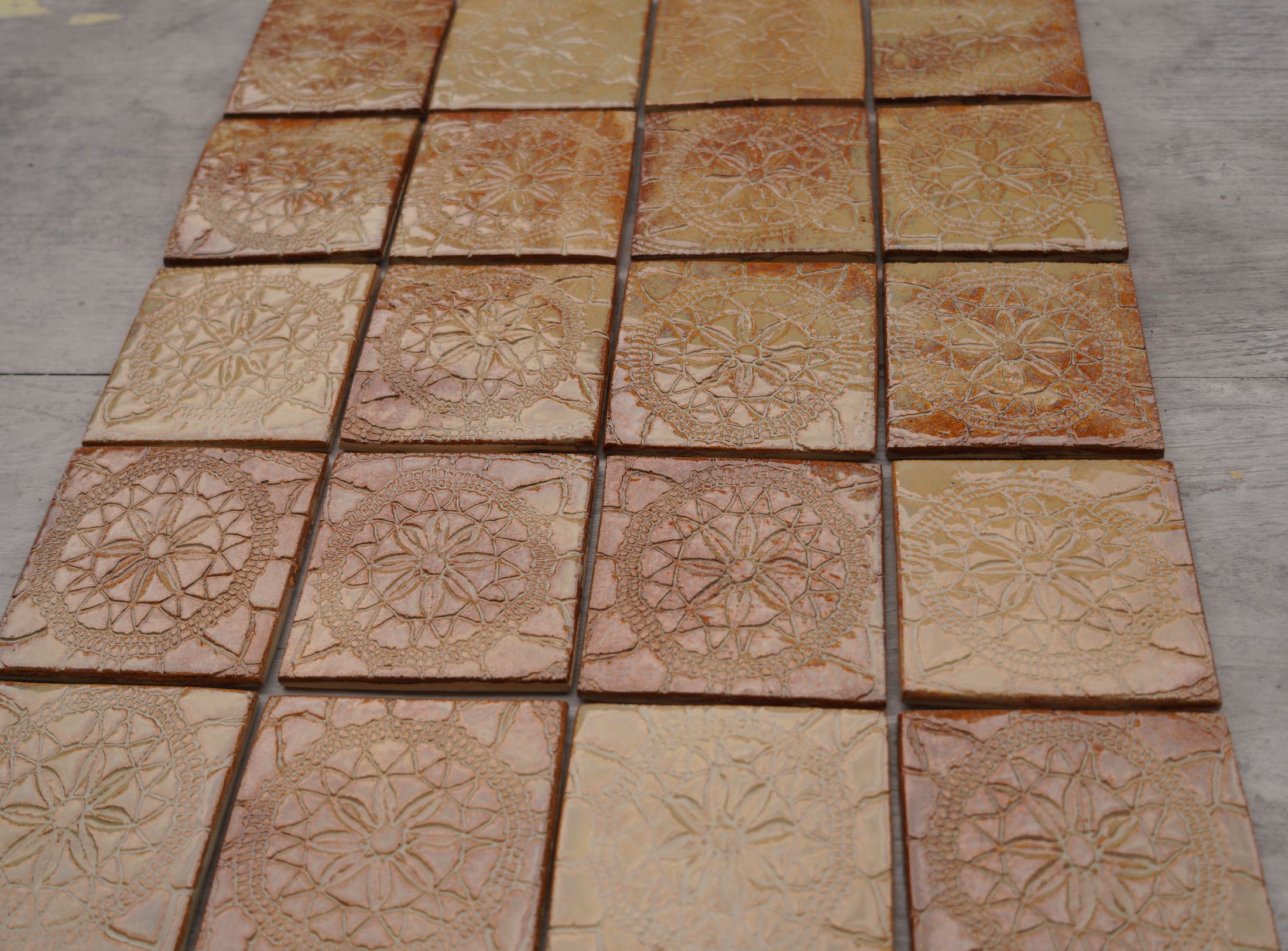 Rose glaze sample tiles shown on Belgian stone.