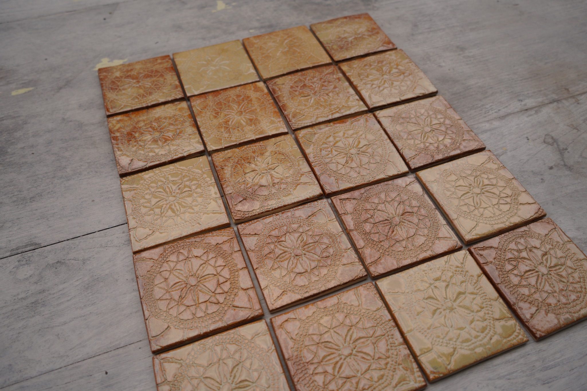 Close view of warm Flemish Relief tiles with handmade surface variation.