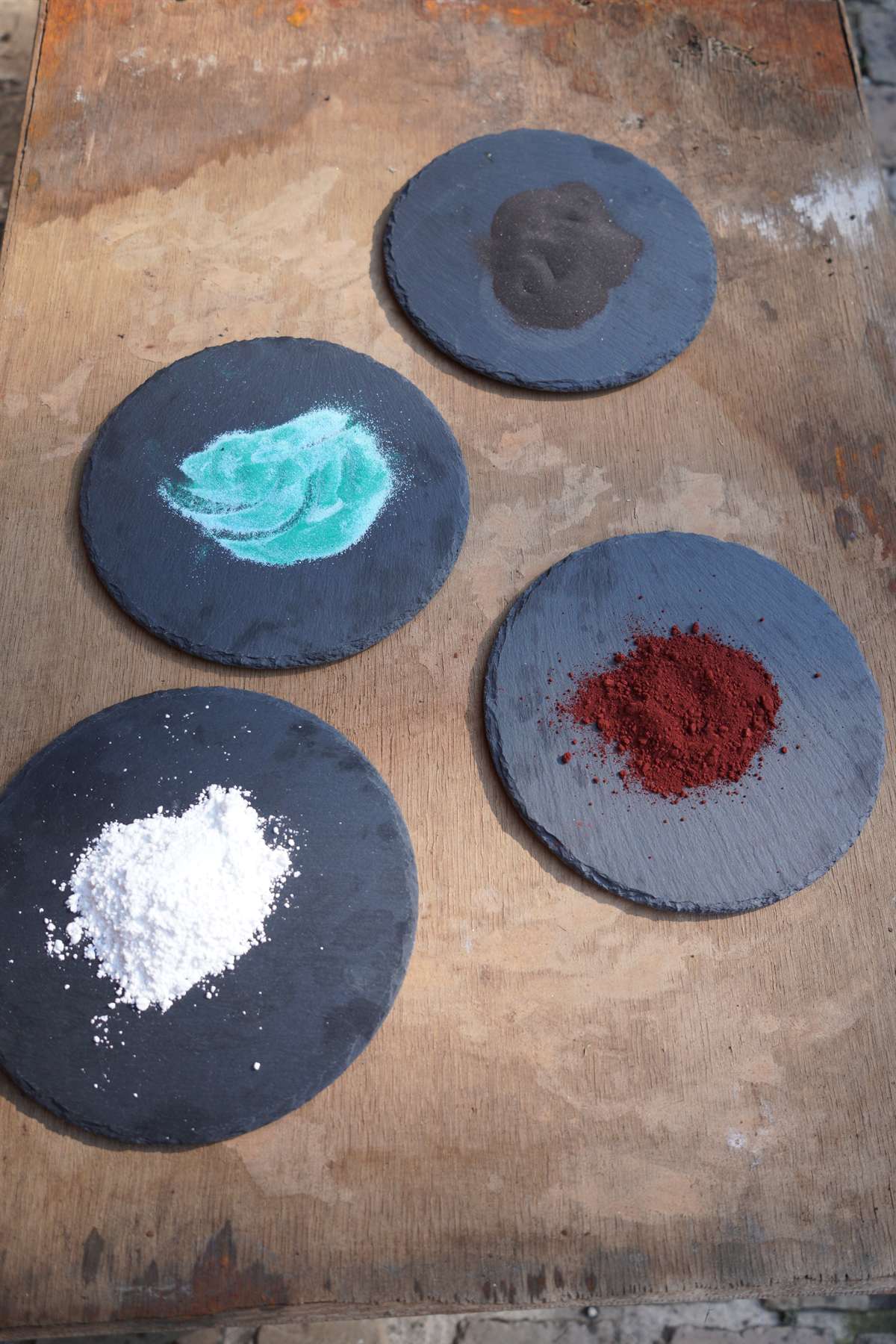 Ceramic pigments measured on slate palettes in the atelier.