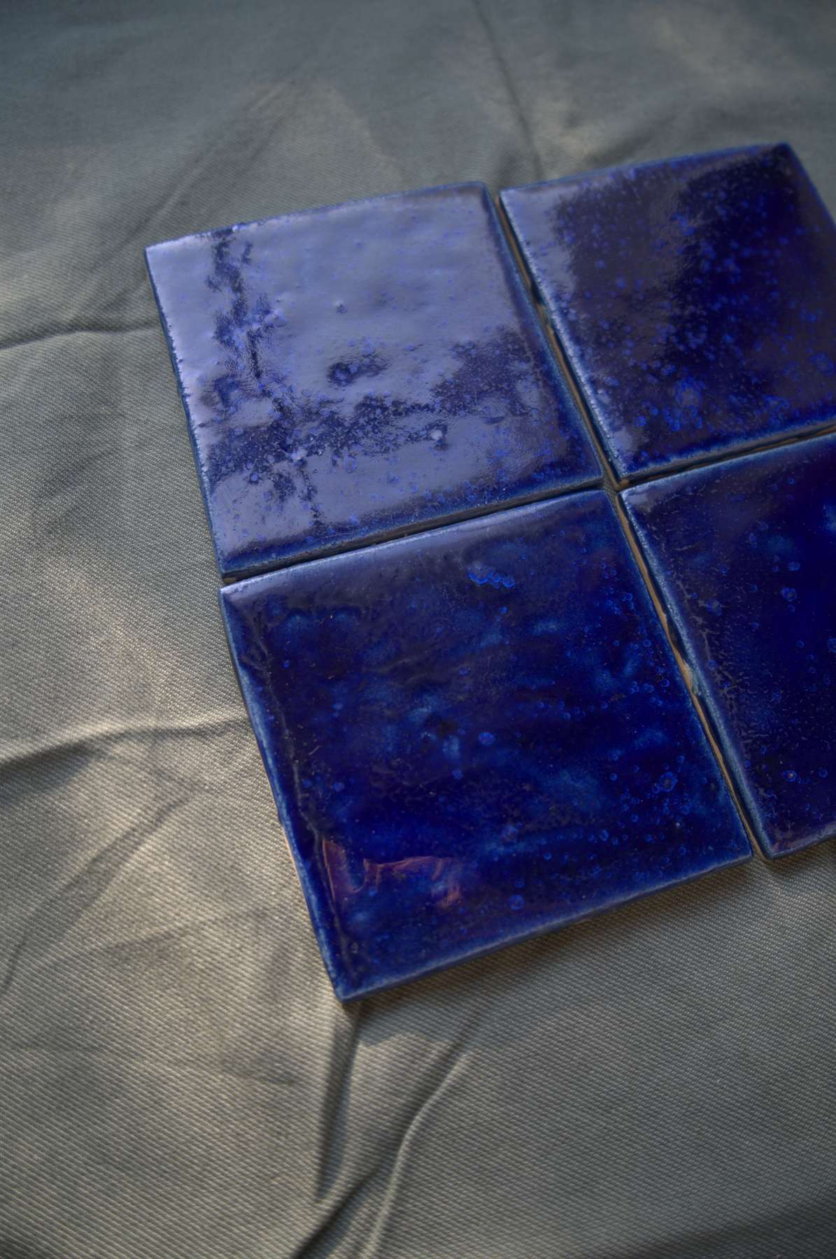 Close view of a single deep blue handmade tile.