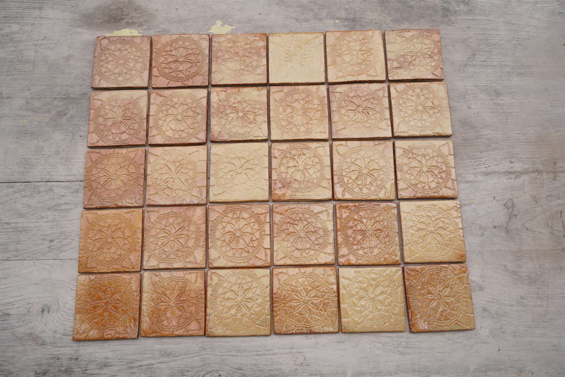 Earth-toned tile field with mineral glaze variation.