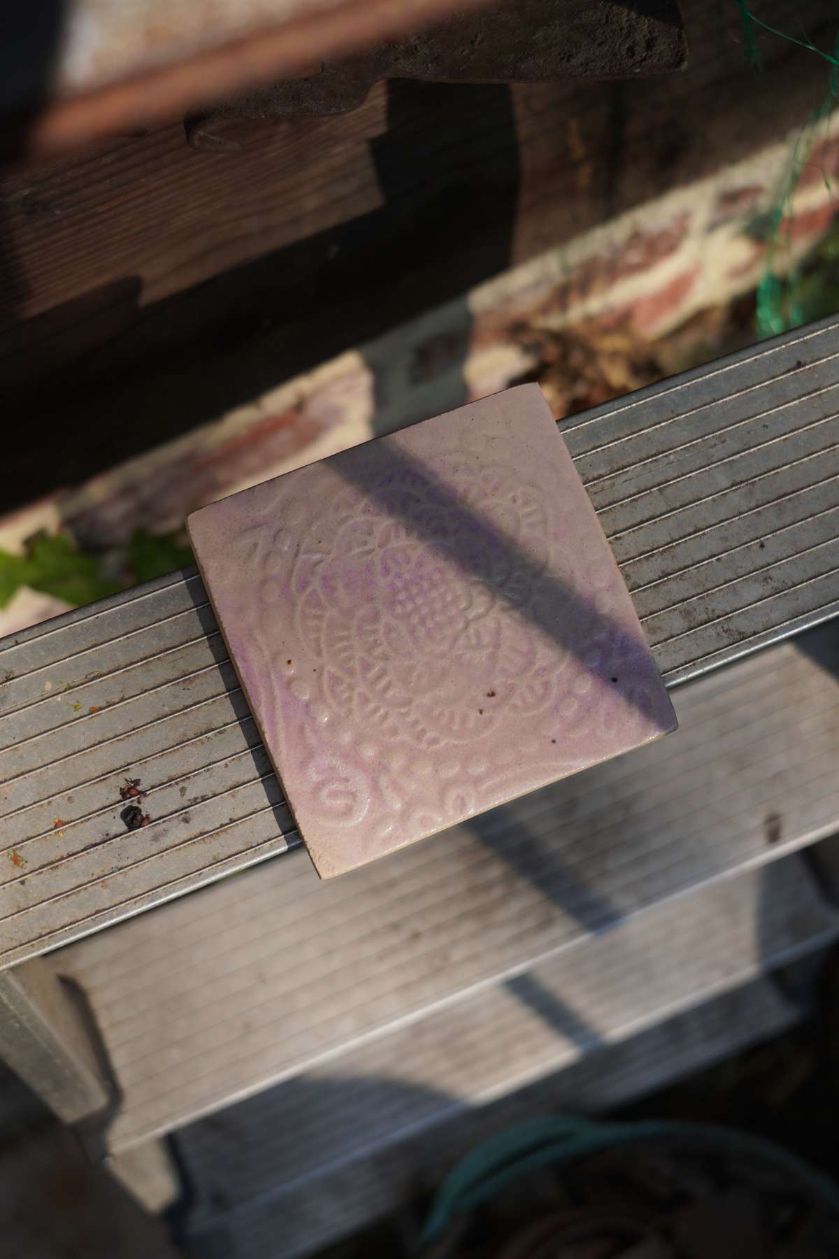Pale rose relief tile shown in natural light.