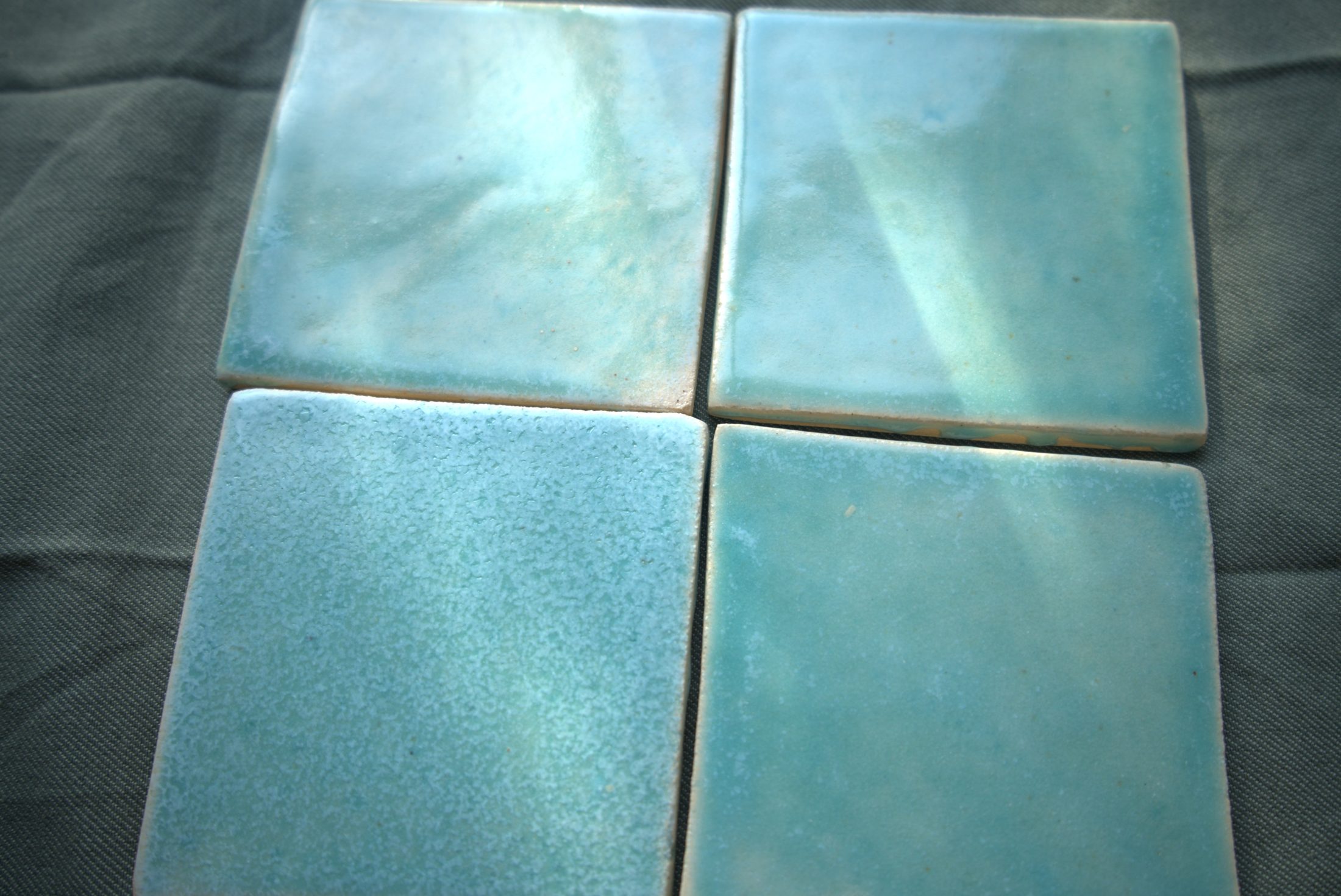 Single verdigris relief tile showing glaze pooling in the pattern.